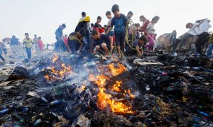 Palestinians search for food among burnt debris in the aftermath of an Israeli strike on an area designated for displaced people, in Rafah in the southern Gaza Strip on May 27, 2024. — Reuters