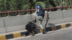 A member of Armed Police Battalion (APBn) stomping a protester as he falls to the ground in the capital's Jatrabari on Thursday, 18 July 2024. Photo: Mehedi Hasan/TBS