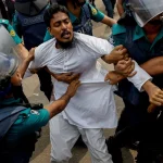 Police detains a man who was not leaving the University of Dhaka premises, a day after the clash between Bangladesh Chhatra League, the student wing of the ruling party Bangladesh Awami League, and anti-quota protesters, in Dhaka, Bangladesh, July 17, 2024. Photo: Reuters