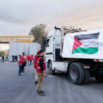 Egyptian Red Crecent members monitor trucks carrying humanitarian aid as they enter the Rafah crossing between Egypt and the Gaza Strip, following an agreement between Israel and Hamas on a ceasefire, 12 October 2025. Photo: UNB/AP